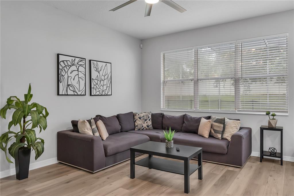 506 Kettering Road Davenport, FL 33897 - Photo 13 of 45 a living room with furniture and a large window