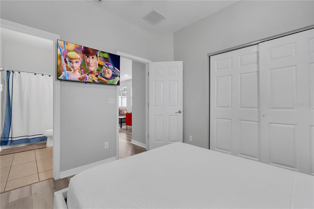 506 Kettering Road Davenport, FL 33897 - Photo 17 of 45 a bedroom with a bed and a cabinets