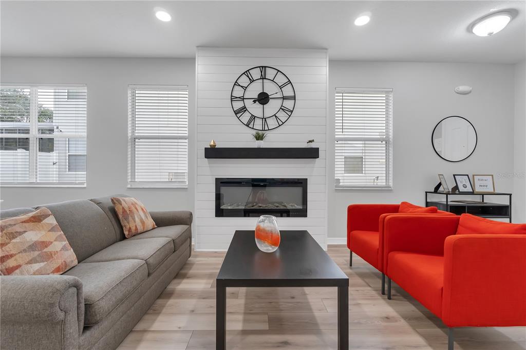 506 Kettering Road Davenport, FL 33897 - Photo 2 of 45 a living room with furniture a rug and a fireplace