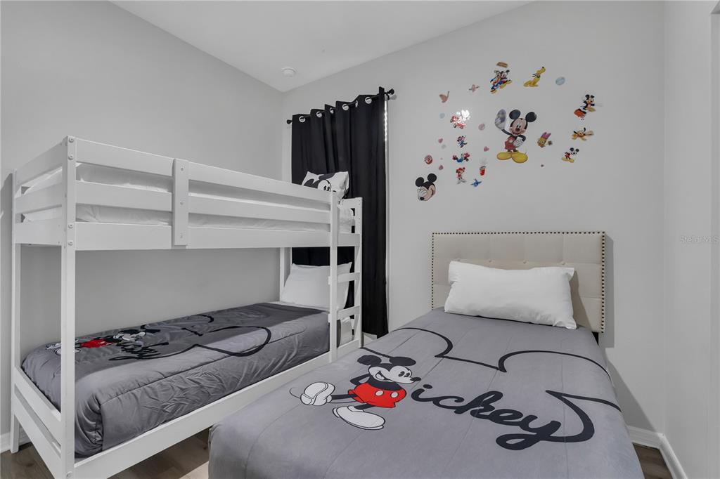 506 Kettering Road Davenport, FL 33897 - Photo 21 of 45 a bedroom with a bed and dresser