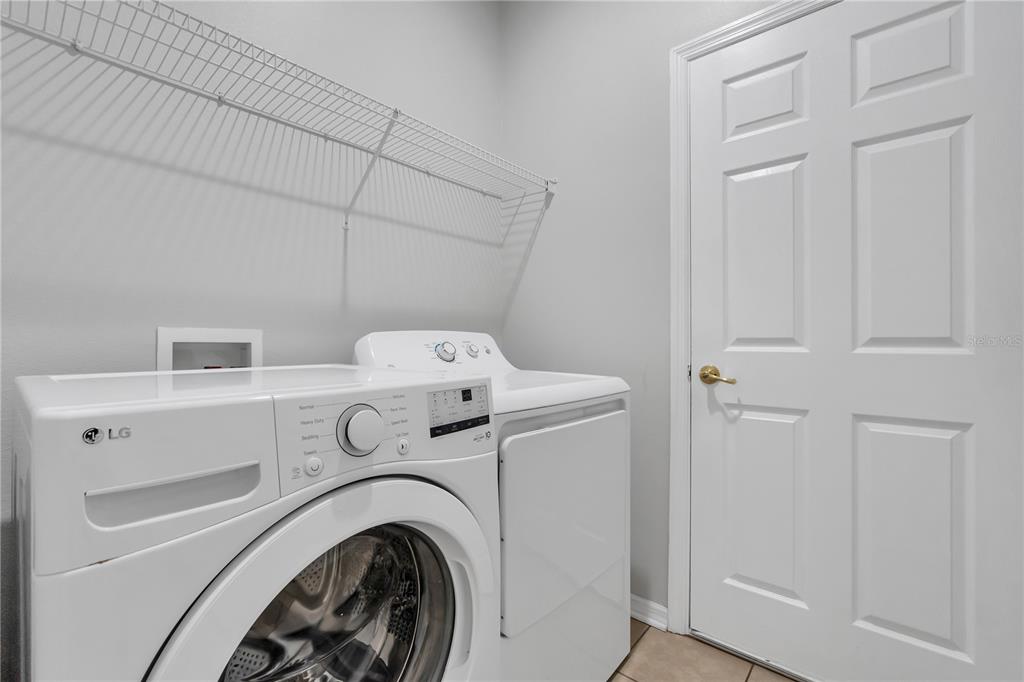 506 Kettering Road Davenport, FL 33897 - Photo 22 of 45 a utility room with dryer and washer