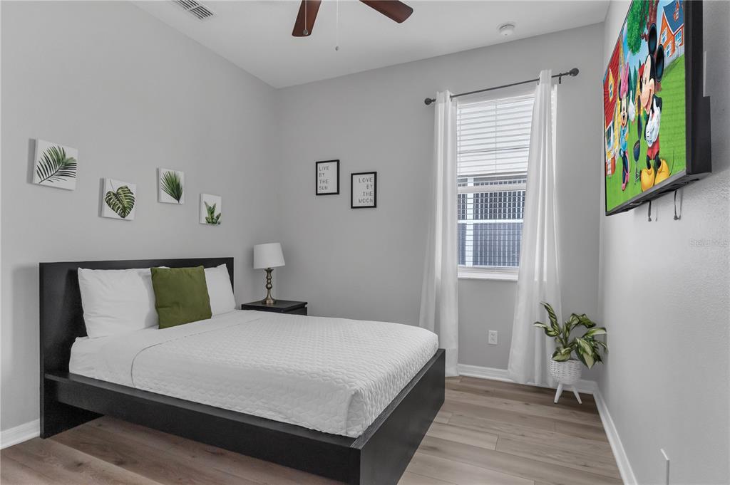 506 Kettering Road Davenport, FL 33897 - Photo 23 of 45 a bedroom with a bed and a painting on the wall