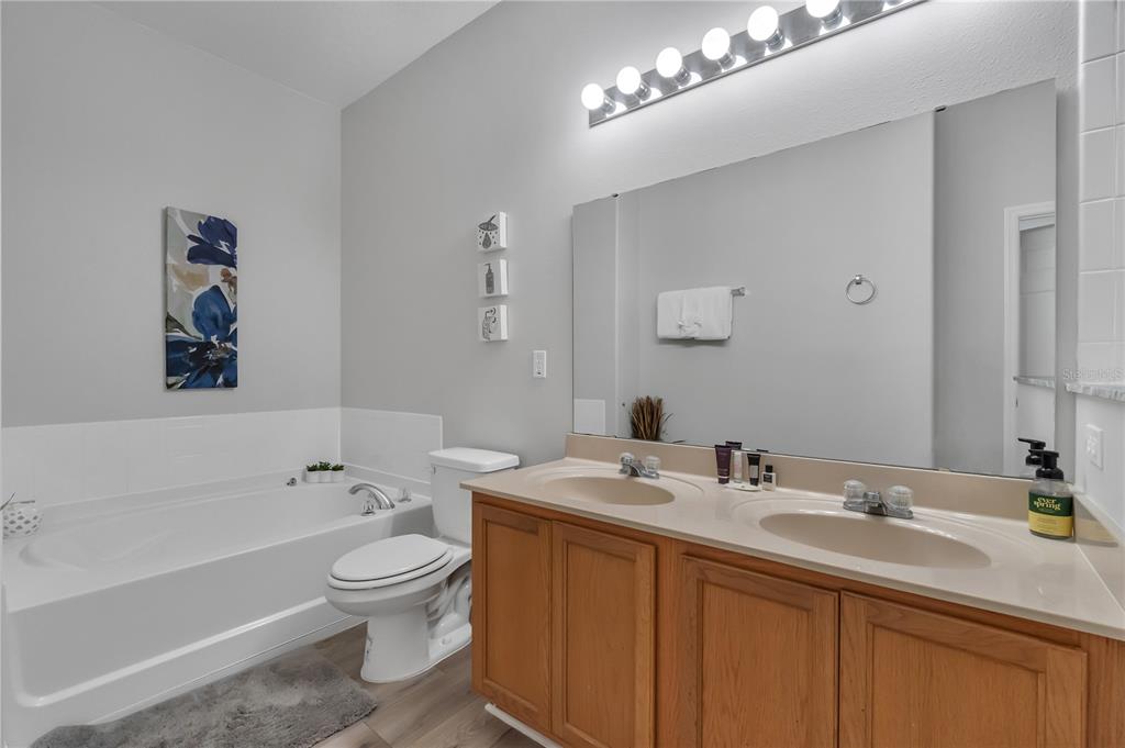 506 Kettering Road Davenport, FL 33897 - Photo 28 of 45 a bathroom with a sink a toilet and a bathtub