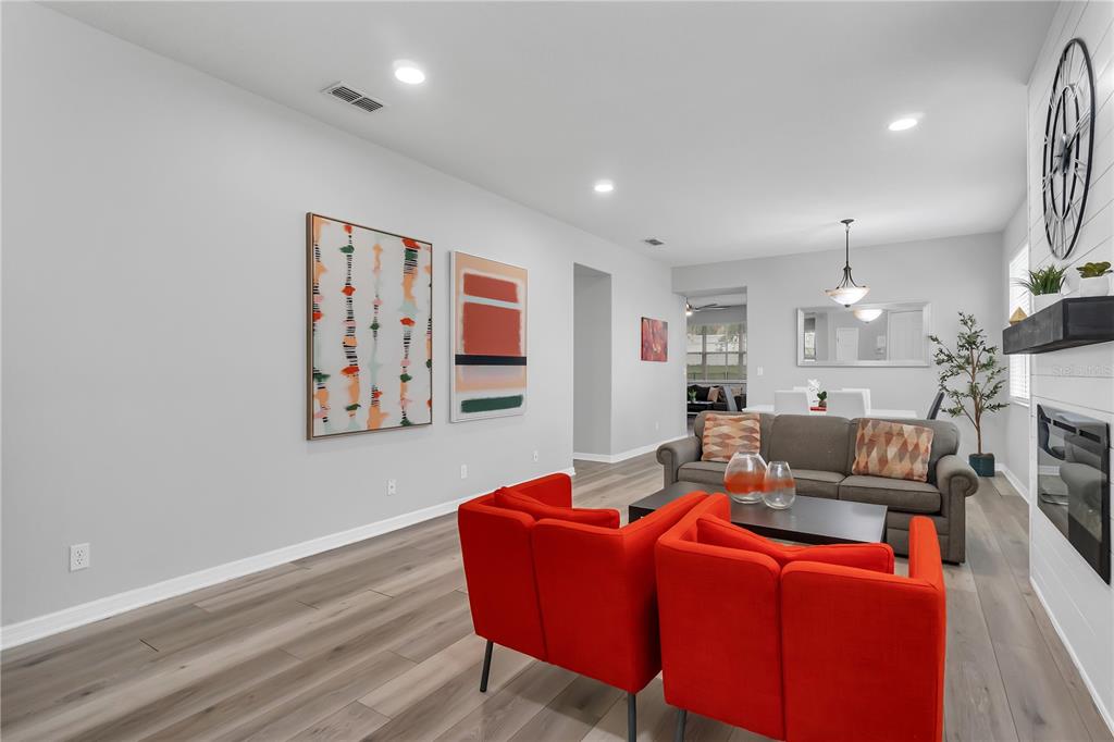 506 Kettering Road Davenport, FL 33897 - Photo 3 of 45 a living room with furniture and a chandelier