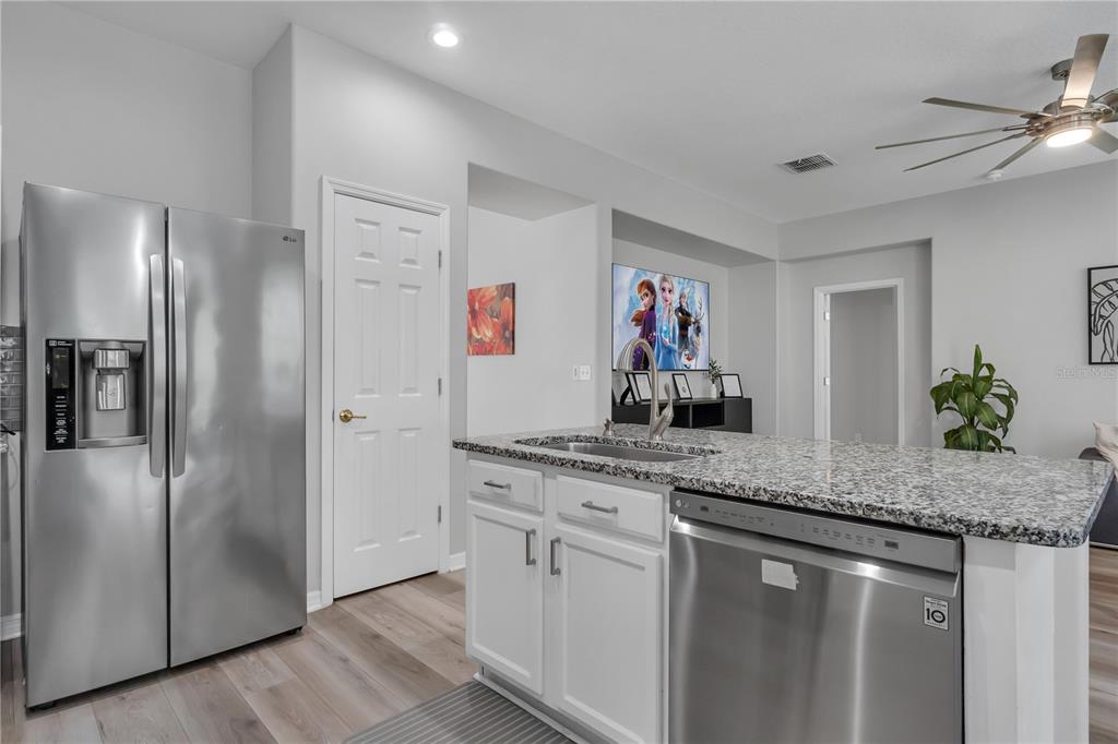 506 Kettering Road Davenport, FL 33897 - Photo 8 of 45 a kitchen with stainless steel appliances granite countertop a refrigerator and a sink