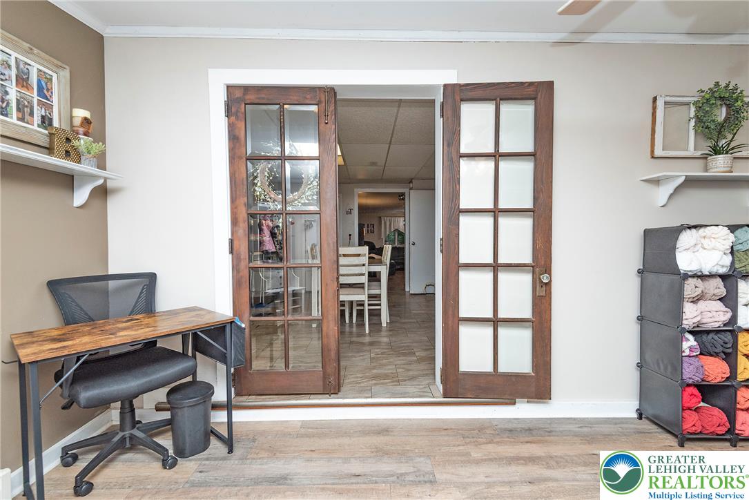 1114 Fox Gap Road Bangor, PA 18013 - Photo 34 of 63 Double French doors connect the interior rooms over durable wood-look flooring.