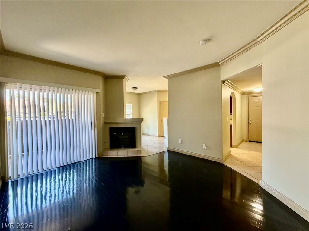 5525 West Flamingo Road, Unit 1019 Las Vegas, NV 89103 - Photo 8 of 18 Rich hardwood floors complement a corner fireplace and ample natural light.