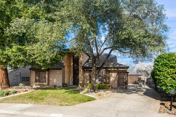 a view of a patio with a table and chairs under an umbrella