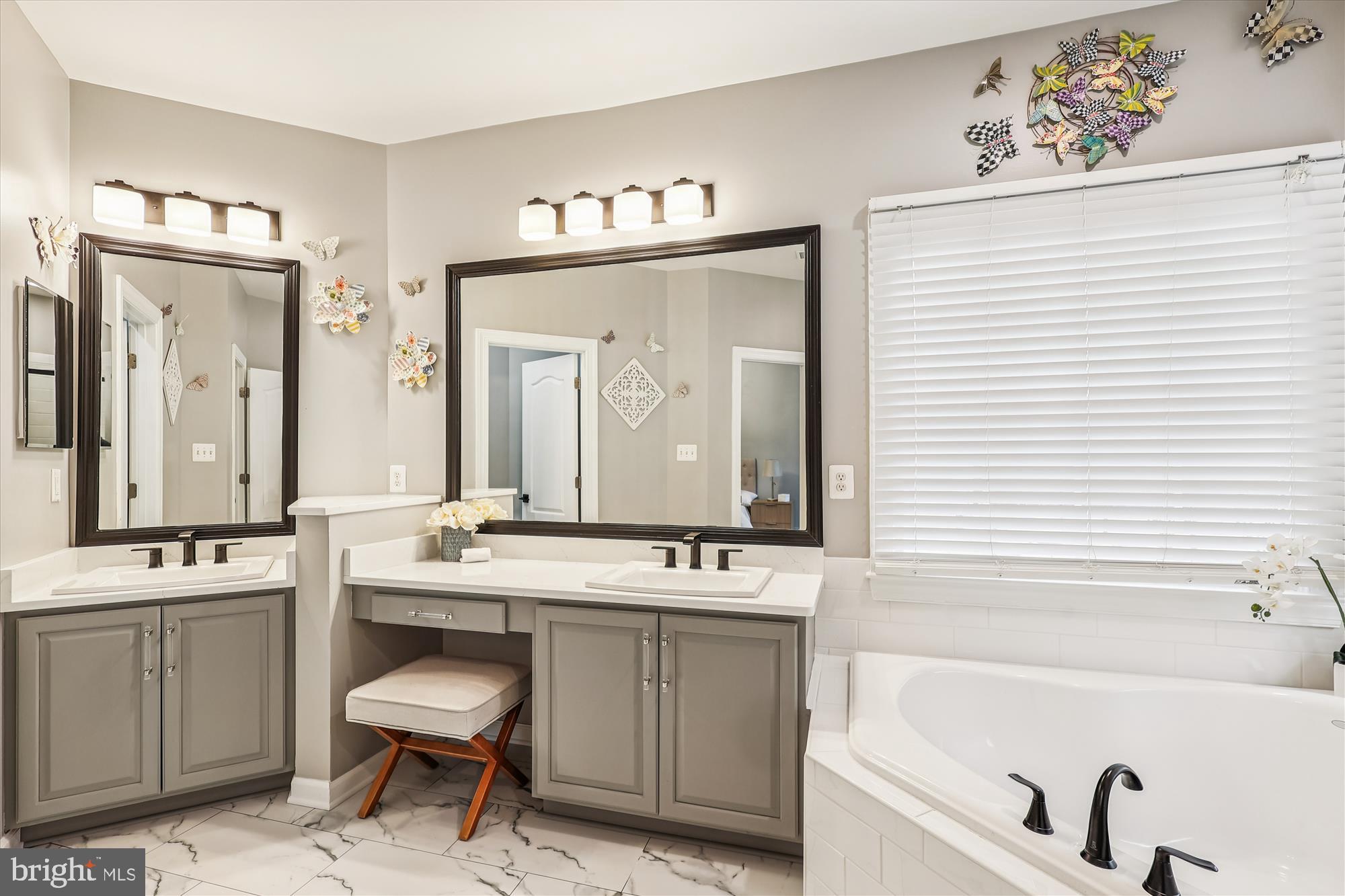 706 Crisfield Way Annapolis, MD 21401 - Photo 25 of 71 a bathroom with a sink a mirror a bathtub and a window