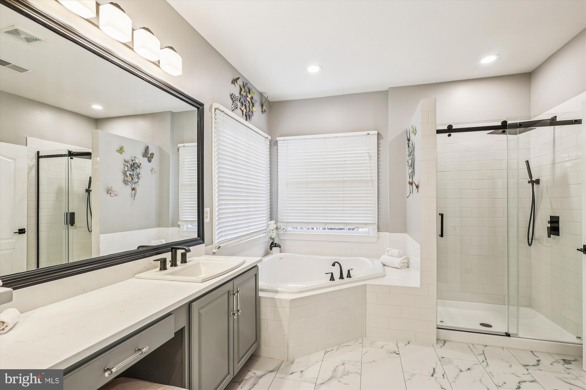 706 Crisfield Way Annapolis, MD 21401 - Photo 26 of 71 a bathroom with a tub sink shower and mirror