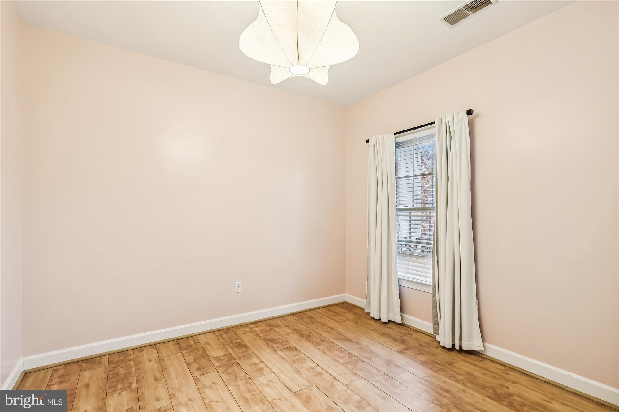 706 Crisfield Way Annapolis, MD 21401 - Photo 33 of 71 an empty room with wooden floor cabinet and windows