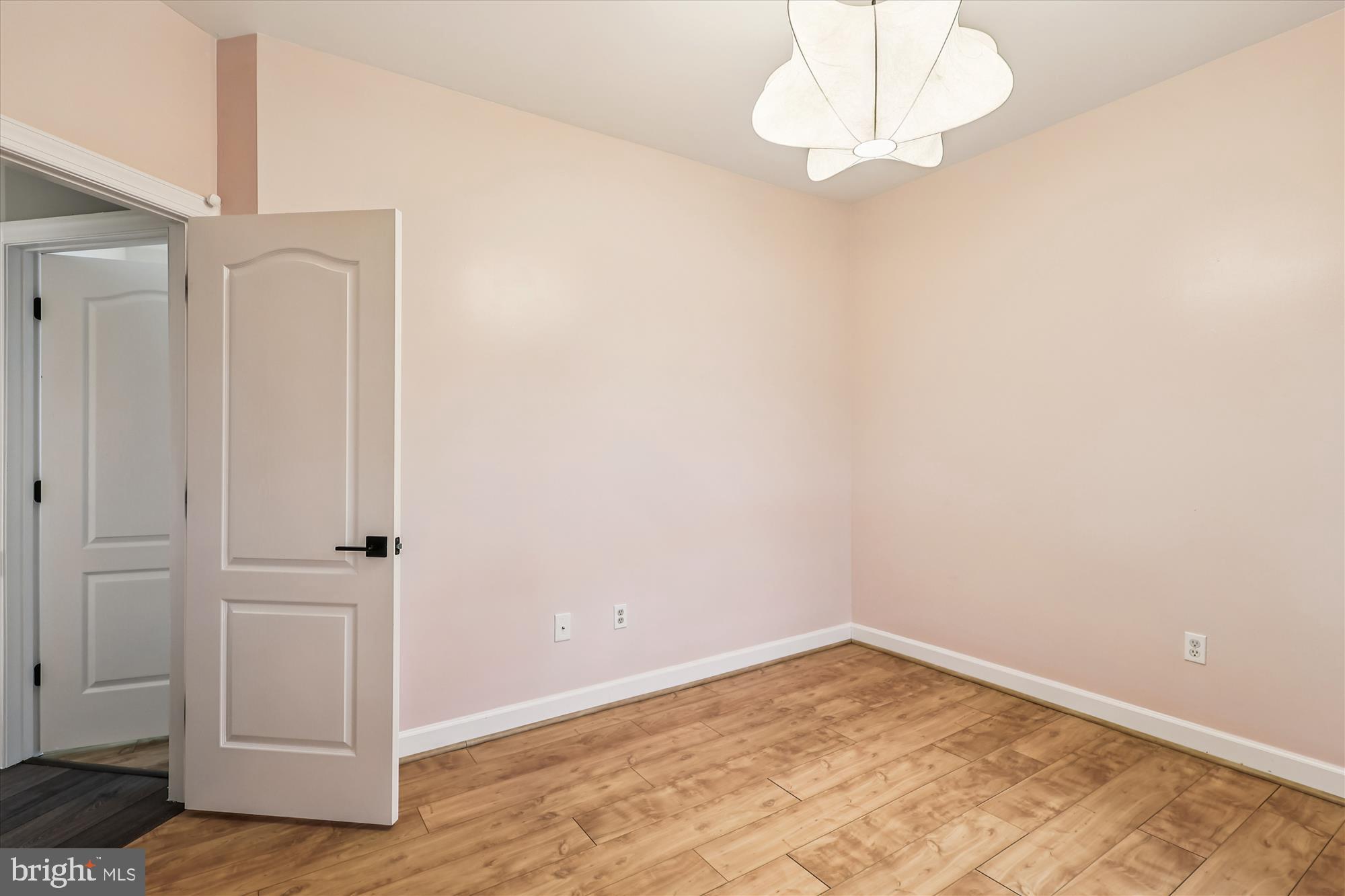 706 Crisfield Way Annapolis, MD 21401 - Photo 34 of 71 an empty room with wooden floor and white walls