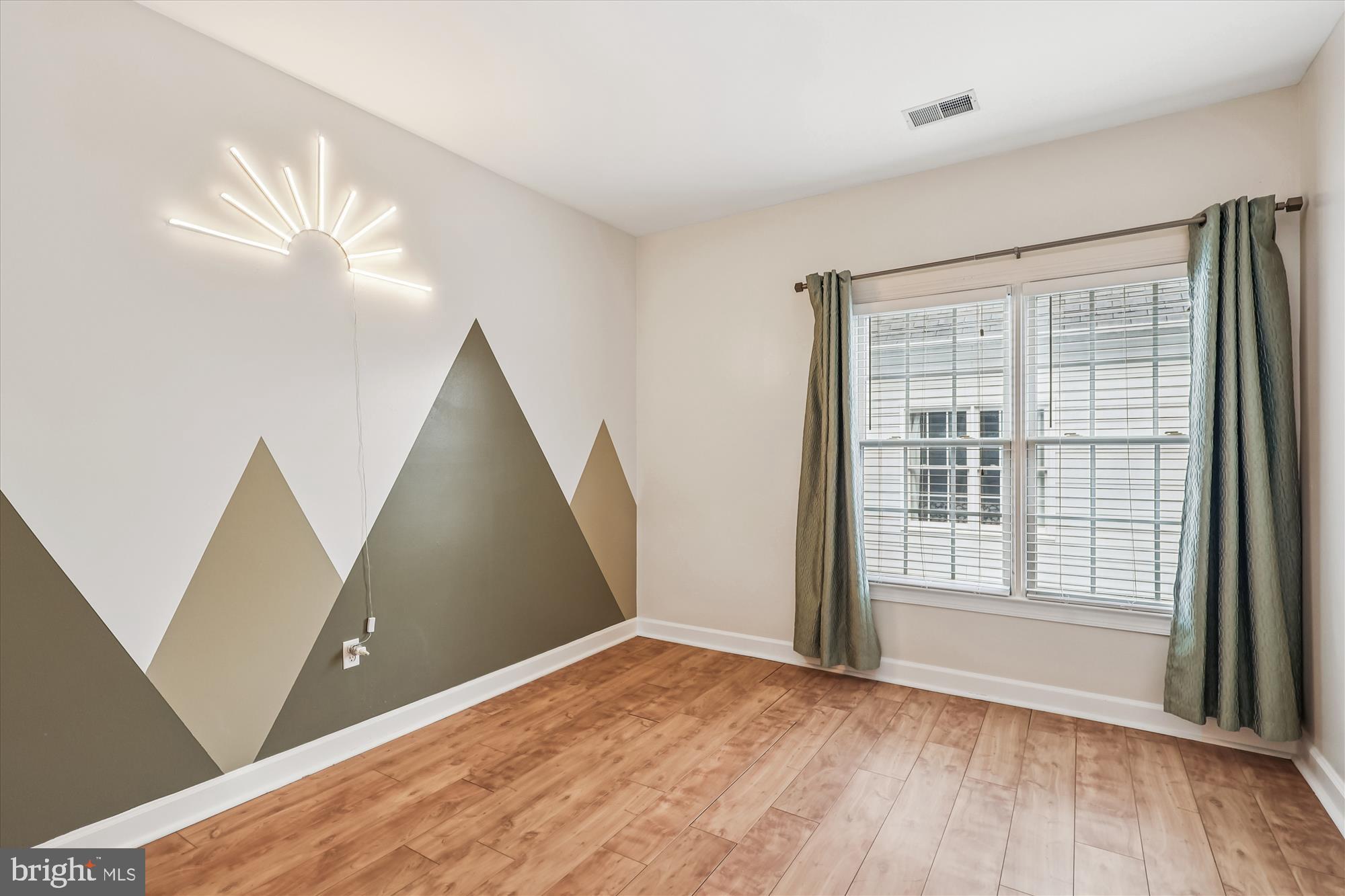 706 Crisfield Way Annapolis, MD 21401 - Photo 36 of 71 a view of an empty room with wooden floor and a window