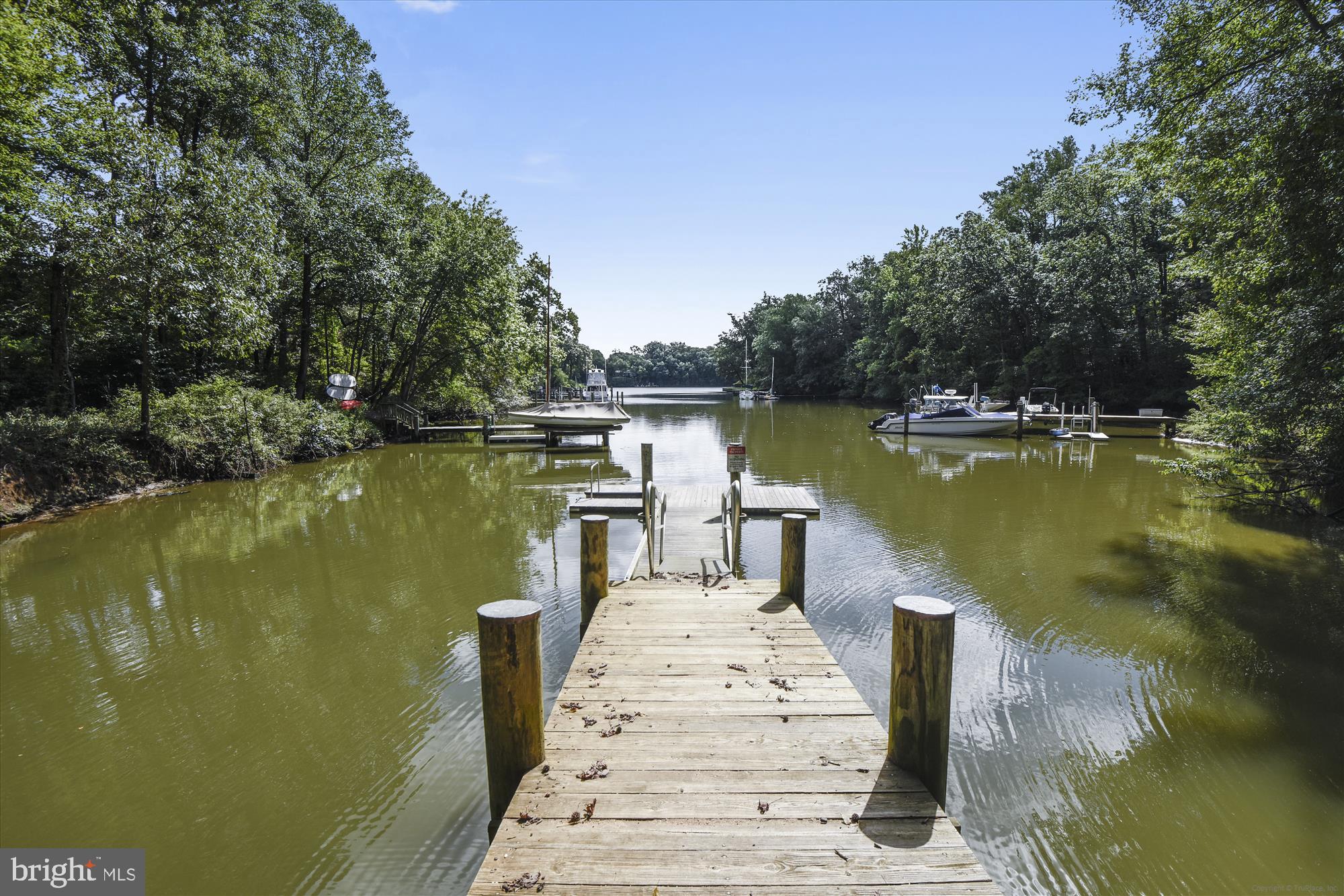 706 Crisfield Way Annapolis, MD 21401 - Photo 58 of 71 a view of a lake with boats and trees in the background