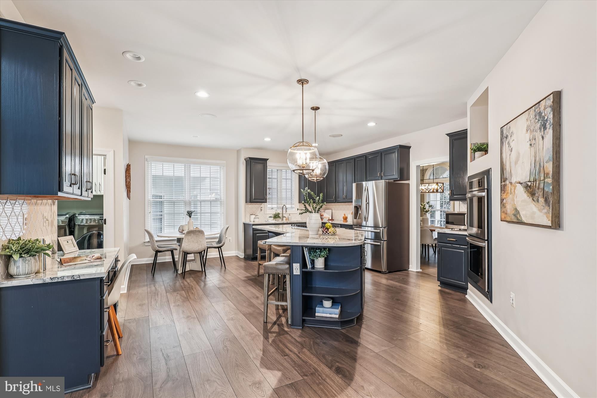 706 Crisfield Way Annapolis, MD 21401 - Photo 6 of 71 a open kitchen with stainless steel appliances granite countertop a dining table chairs stove refrigerator and cabinets