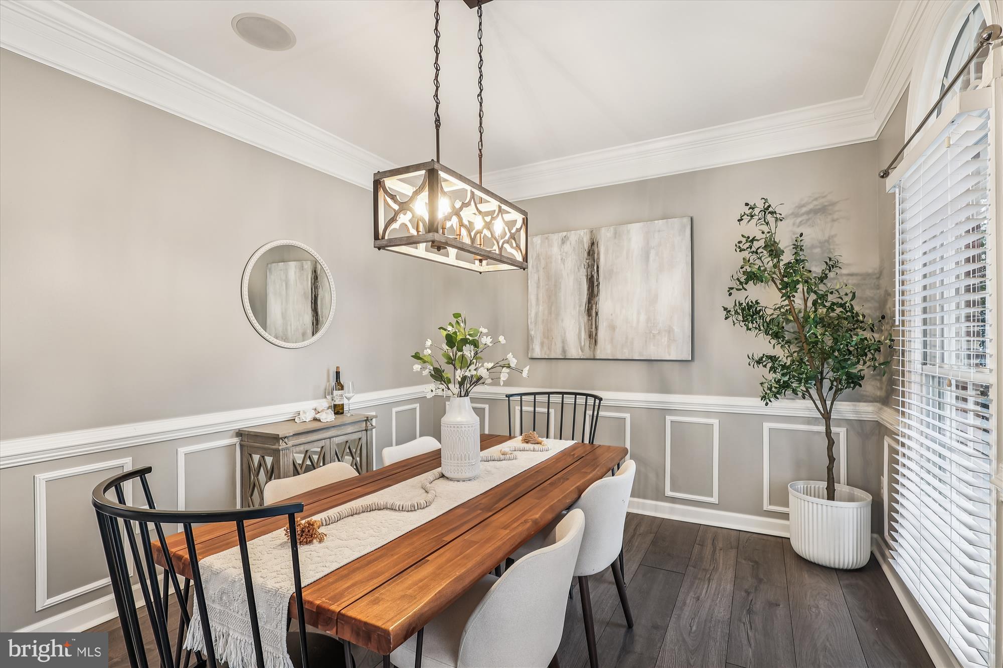 706 Crisfield Way Annapolis, MD 21401 - Photo 9 of 71 a dining room with wooden floor a chandelier a glass table and chairs