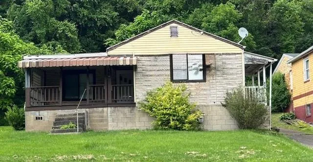 a view of a house with a small yard and a large window
