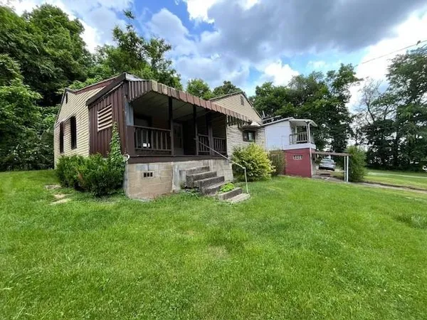 a front view of a house with a garden