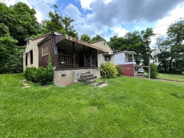 a front view of a house with a garden