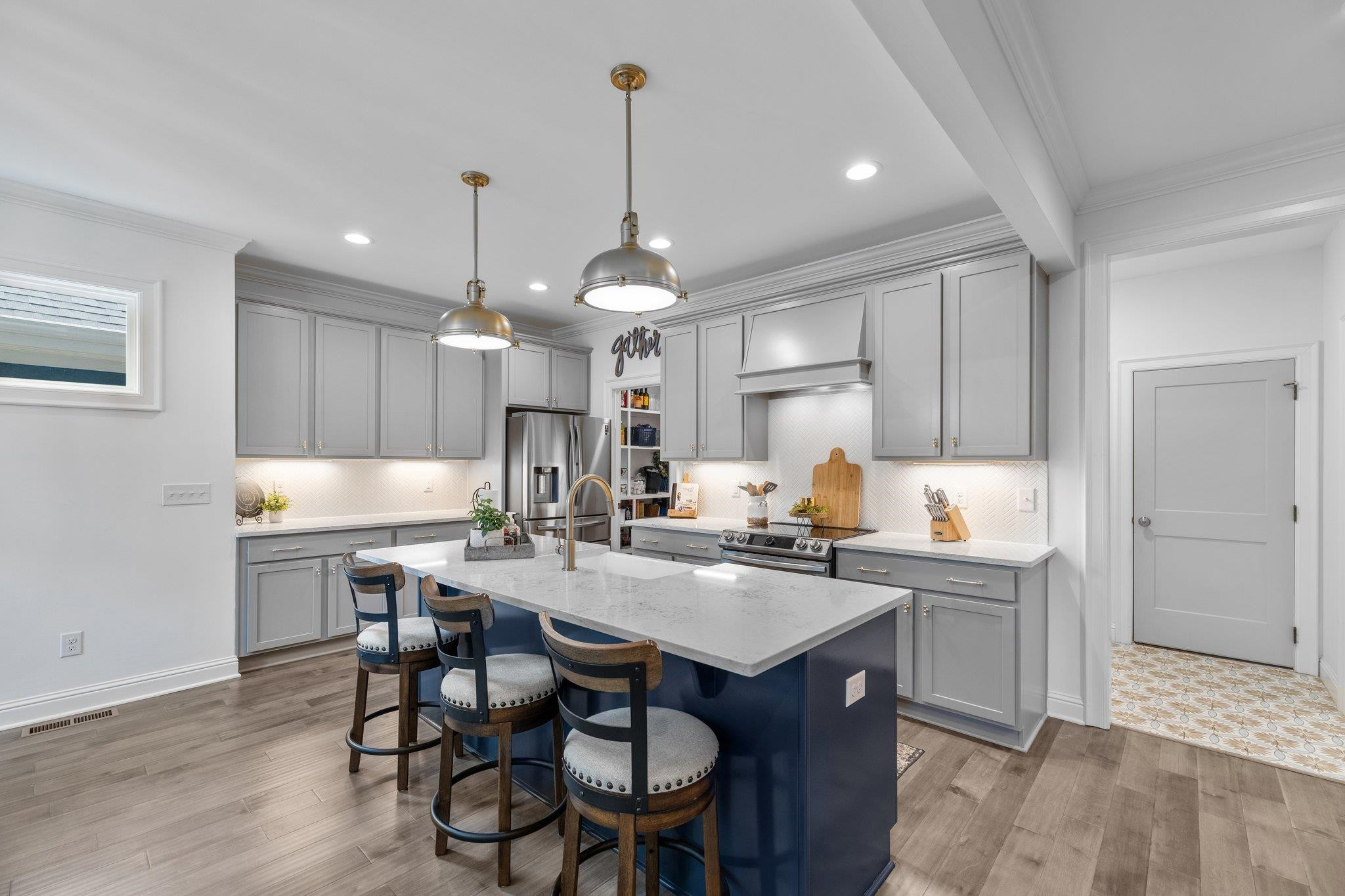 1524 Chalk Road Wake Forest, NC 27587 - Photo 24 of 63 a kitchen with a dining table chairs sink and cabinets
