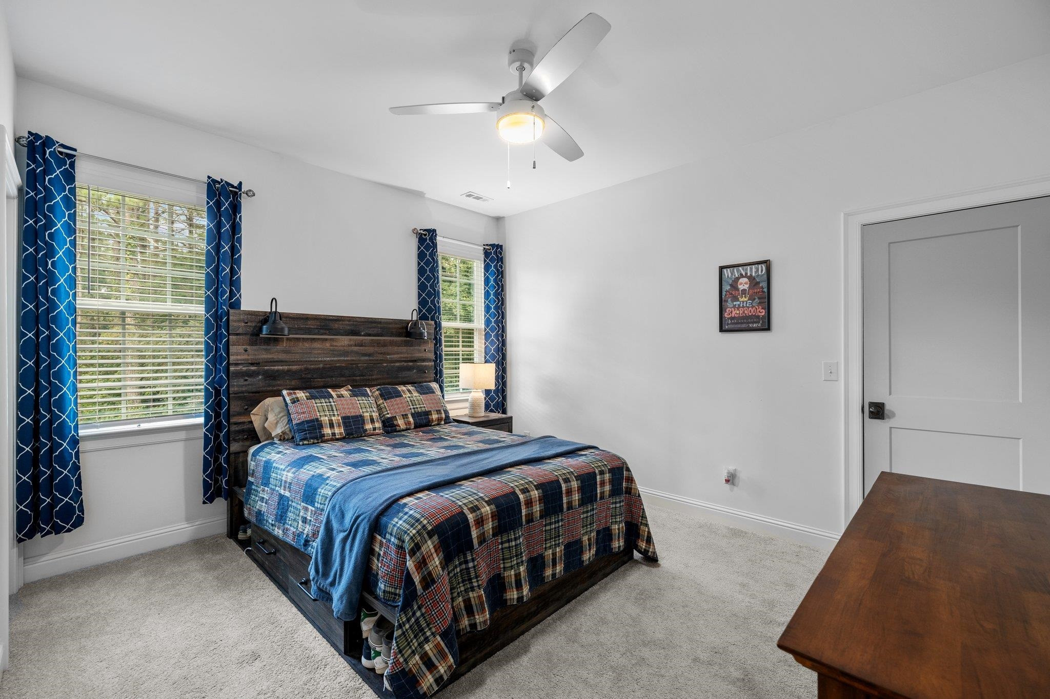 1524 Chalk Road Wake Forest, NC 27587 - Photo 43 of 63 a bedroom with a bed and a chandelier