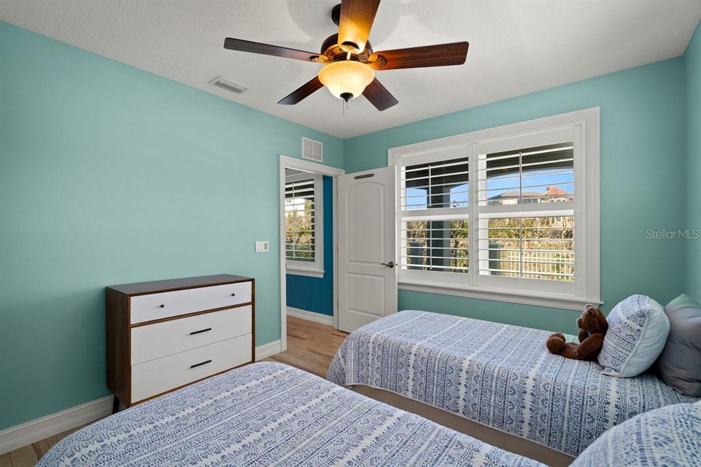 2 Mar Azul North Ponce Inlet, FL 32127 - Photo 14 of 98 a bedroom with a bed and a chandelier