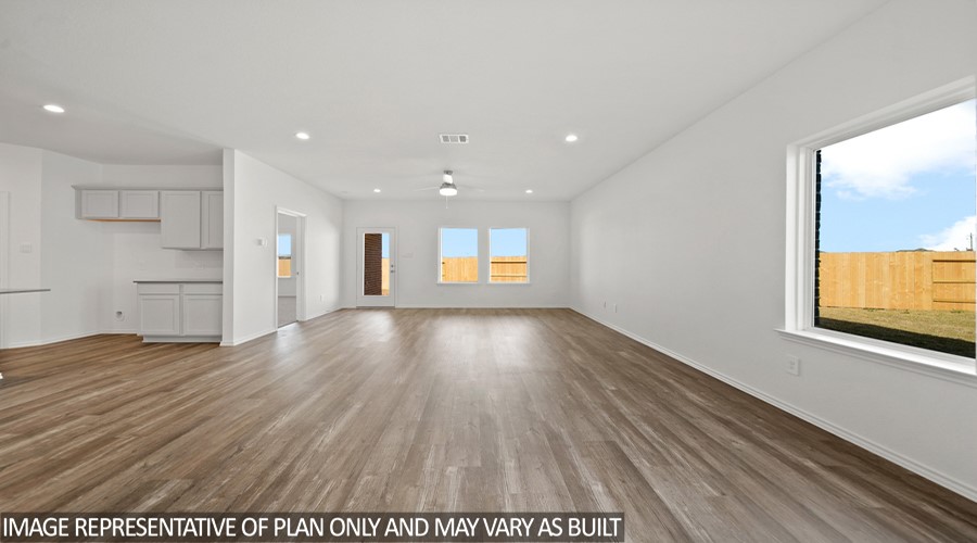15767 Hanson Ridge Drive Montgomery, TX 77316 - Photo 4 of 17 a view of an empty room with wooden floor and a window