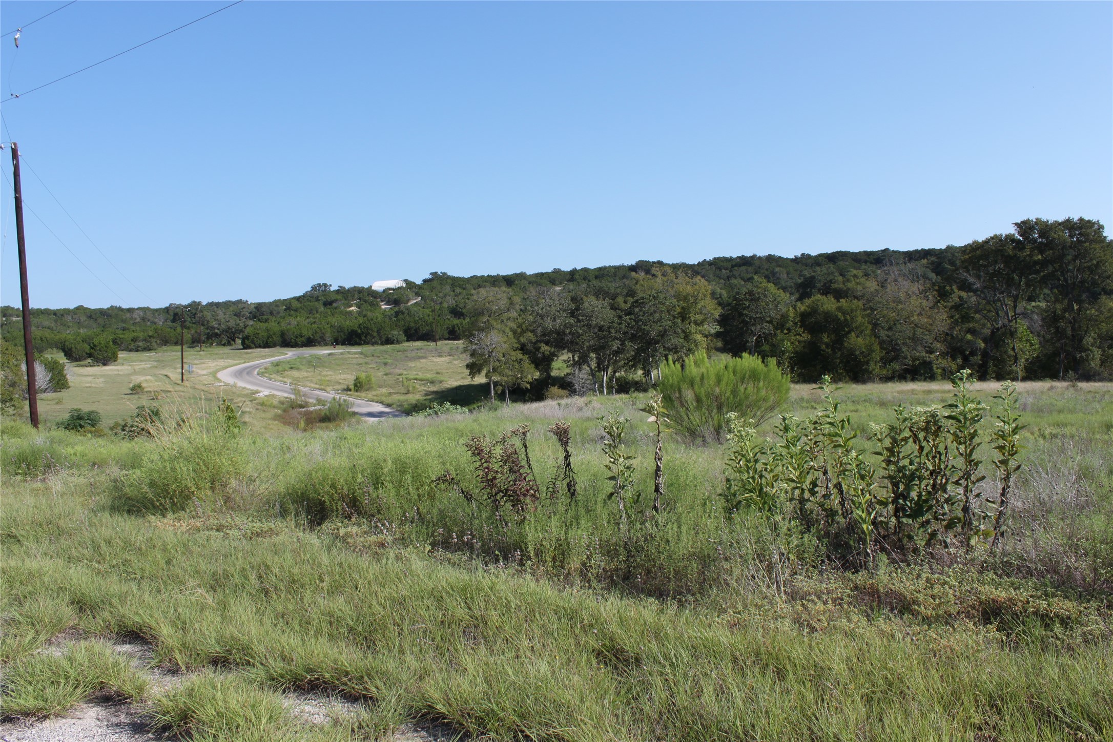 Lot 100 Saddle Ridge Drive Bertram, TX 78605 - Photo 11 of 27 a view of a lake and green valley
