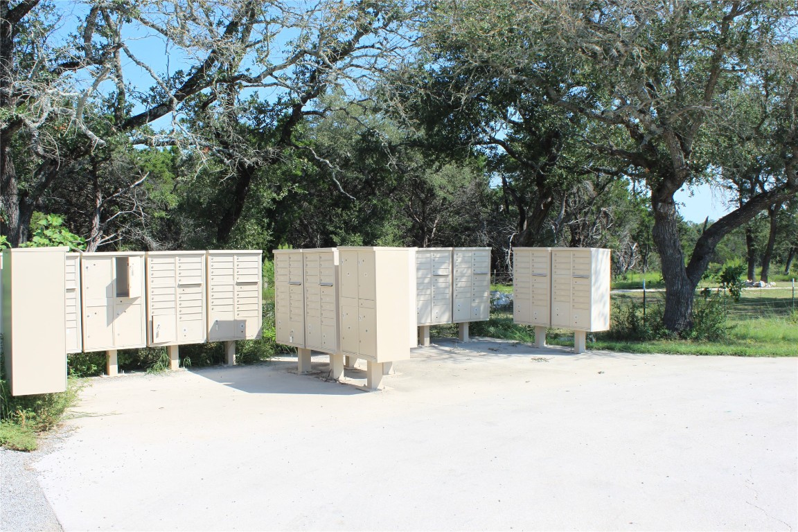 Lot 100 Saddle Ridge Drive Bertram, TX 78605 - Photo 26 of 27 a backyard of a house with garage and trees