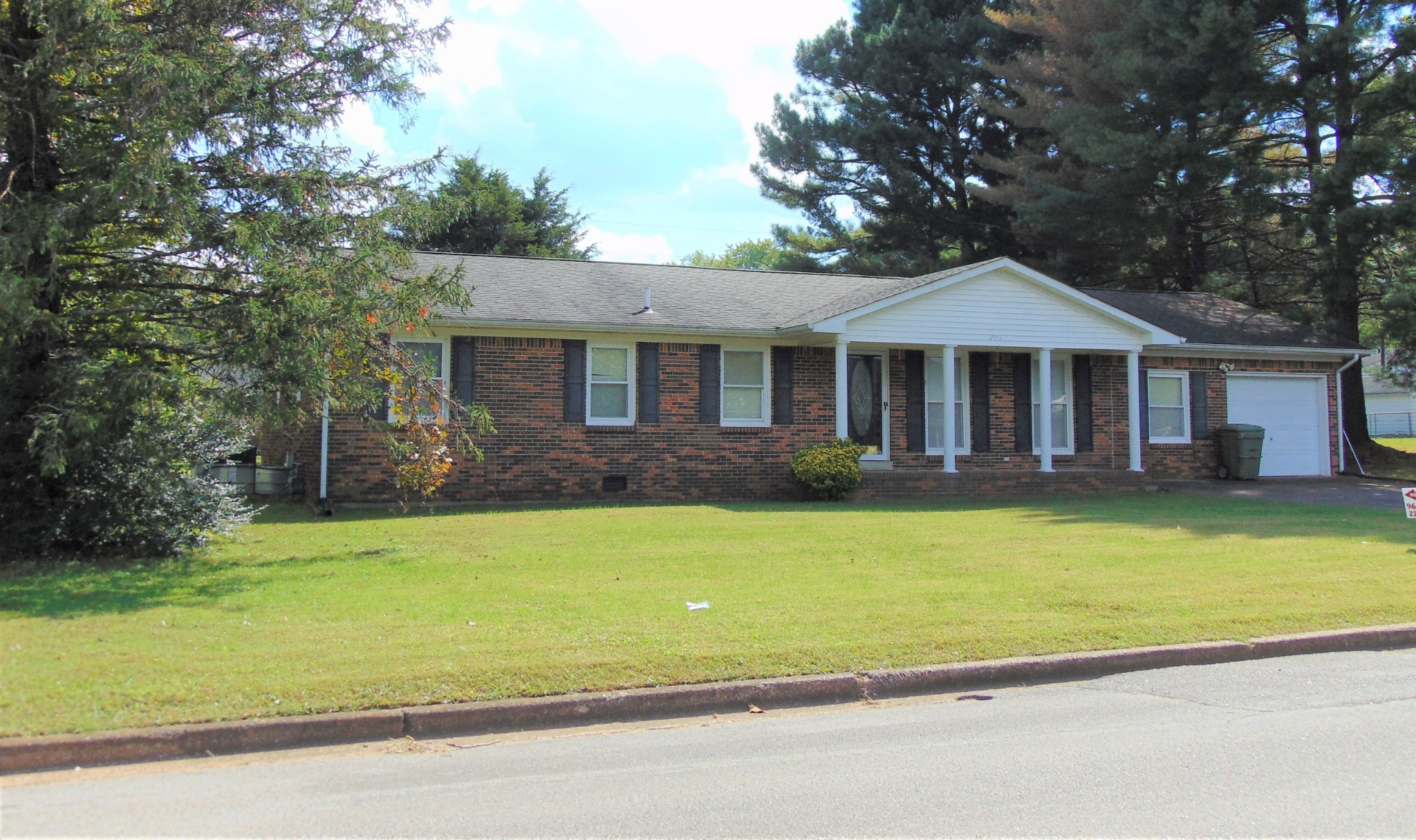 1704 Ann Road Lawrenceburg, TN 38464 - Photo 1 of 20 a front view of a house with a garden and swimming pool