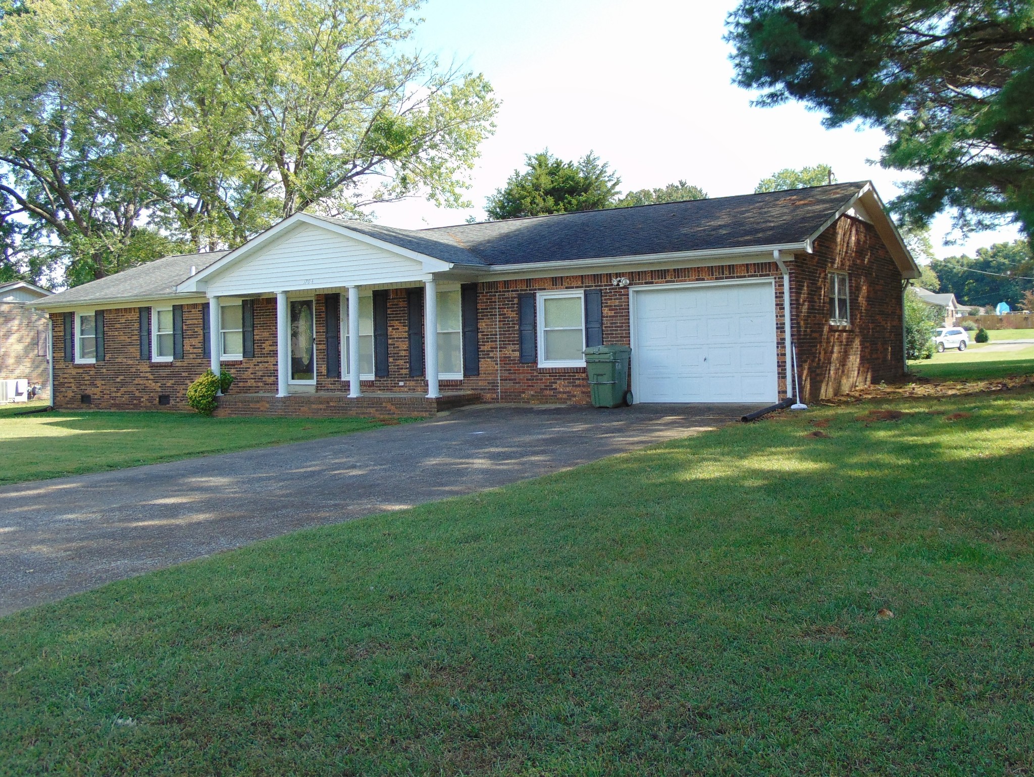 1704 Ann Road Lawrenceburg, TN 38464 - Photo 2 of 20 a front view of a house with a garden and swimming pool