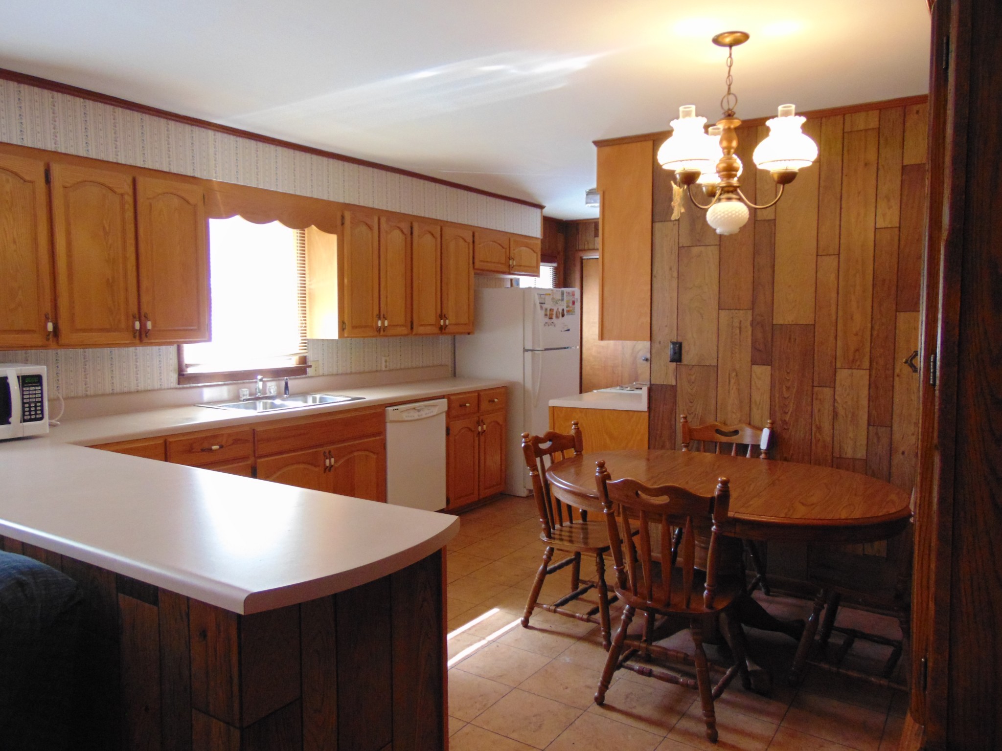 1704 Ann Road Lawrenceburg, TN 38464 - Photo 10 of 20 a kitchen with a table chairs sink and cabinets