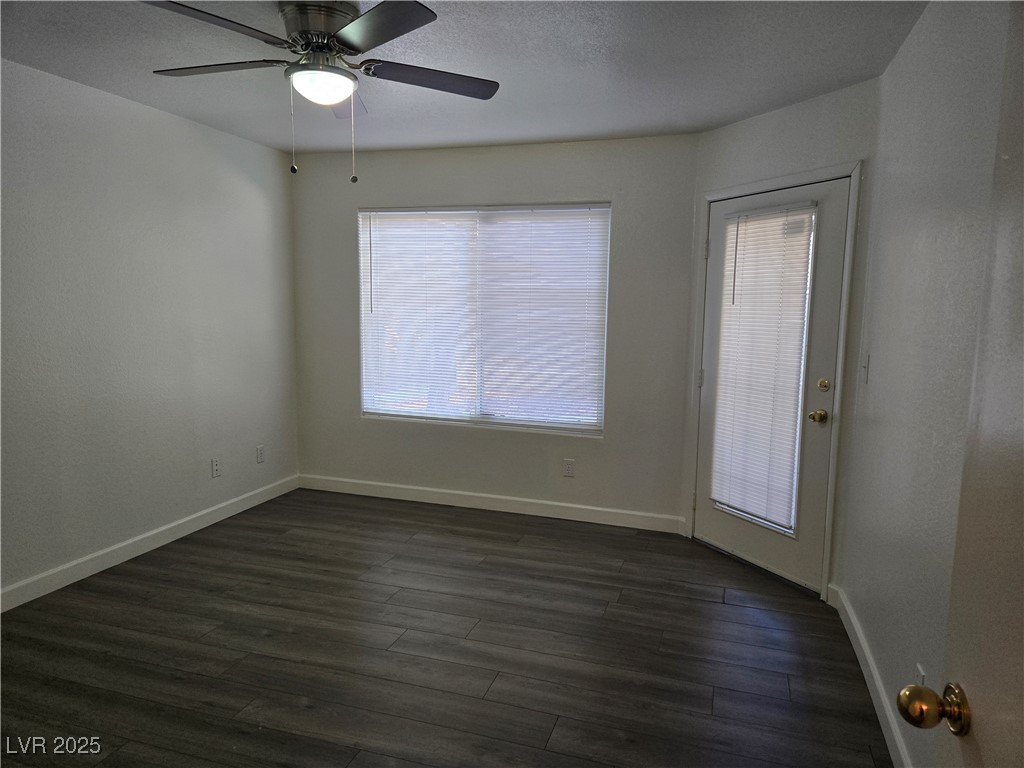 3168 Tarpon, Unit 103 Las Vegas, NV 89120 - Photo 11 of 23 Empty room with dark wood finished floors and a textured ceiling