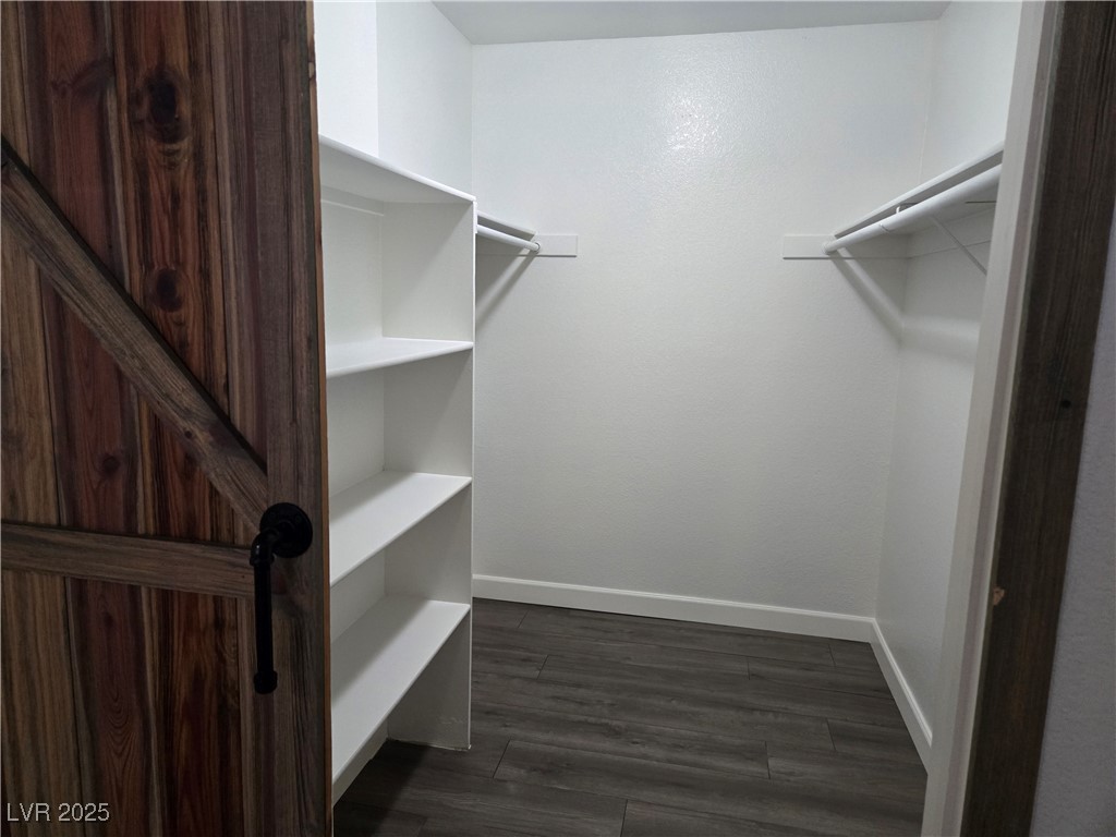 3168 Tarpon, Unit 103 Las Vegas, NV 89120 - Photo 13 of 23 Spacious closet with dark wood-type flooring