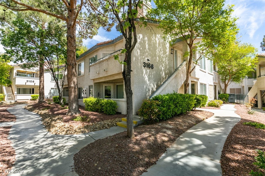 3168 Tarpon, Unit 103 Las Vegas, NV 89120 - Photo 4 of 23 View of building exterior featuring stairway and a residential view