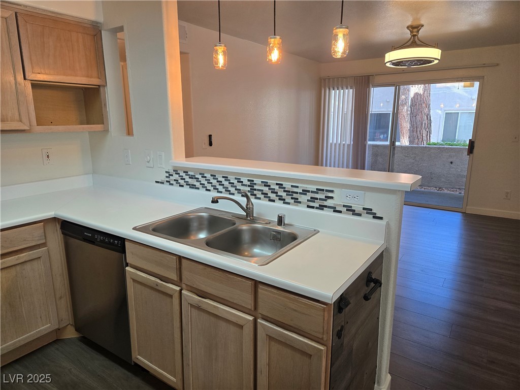3168 Tarpon, Unit 103 Las Vegas, NV 89120 - Photo 6 of 23 Kitchen with light countertops, decorative light fixtures, dishwasher, dark wood-style flooring, and tasteful backsplash