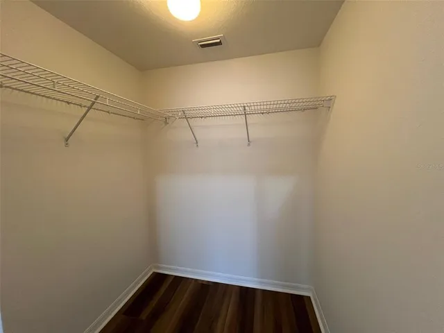 a bathroom with a granite countertop sink a toilet and a mirror
