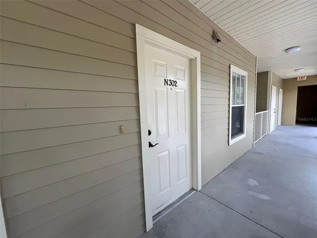 a view of a bathroom with a sink a mirror and a window