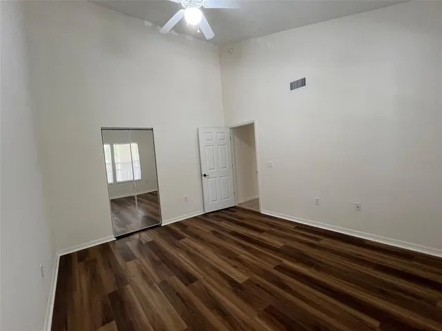 a bathroom with a granite countertop sink a toilet and shower