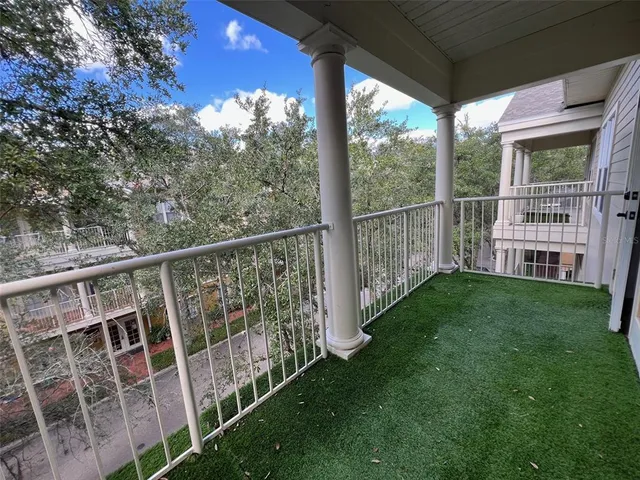 a view of a house with a tree in the background