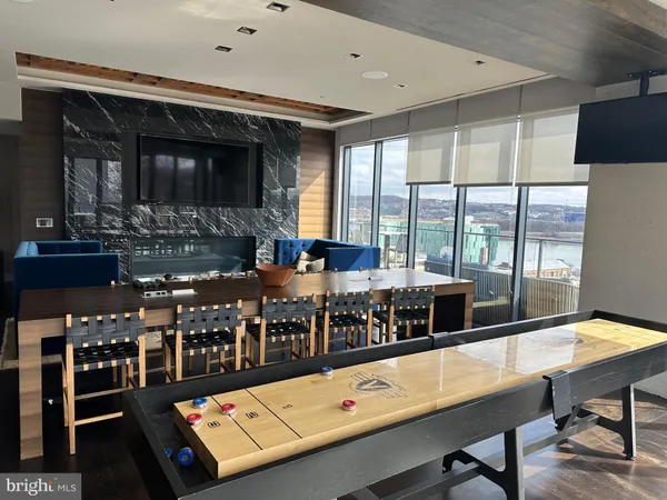a room with furniture pool table and flat screen tv