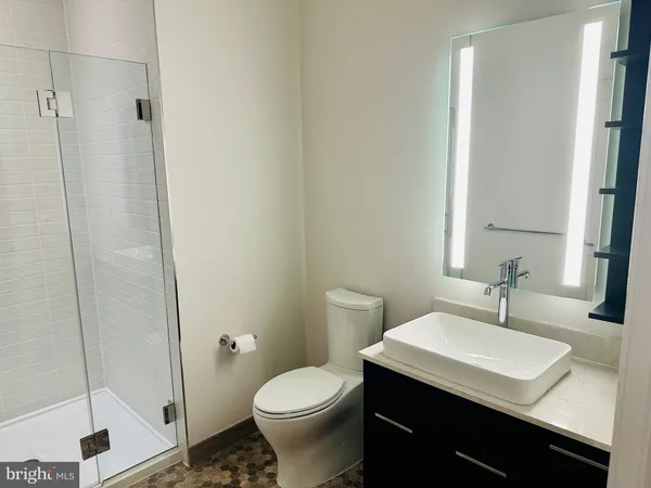 a bathroom with a sink toilet and shower