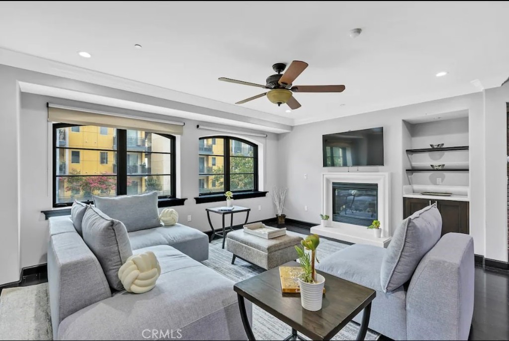 155 Cordova Street, Unit 203 Pasadena, CA 91105 - Photo 17 of 57 a living room with furniture a fireplace and a flat screen tv