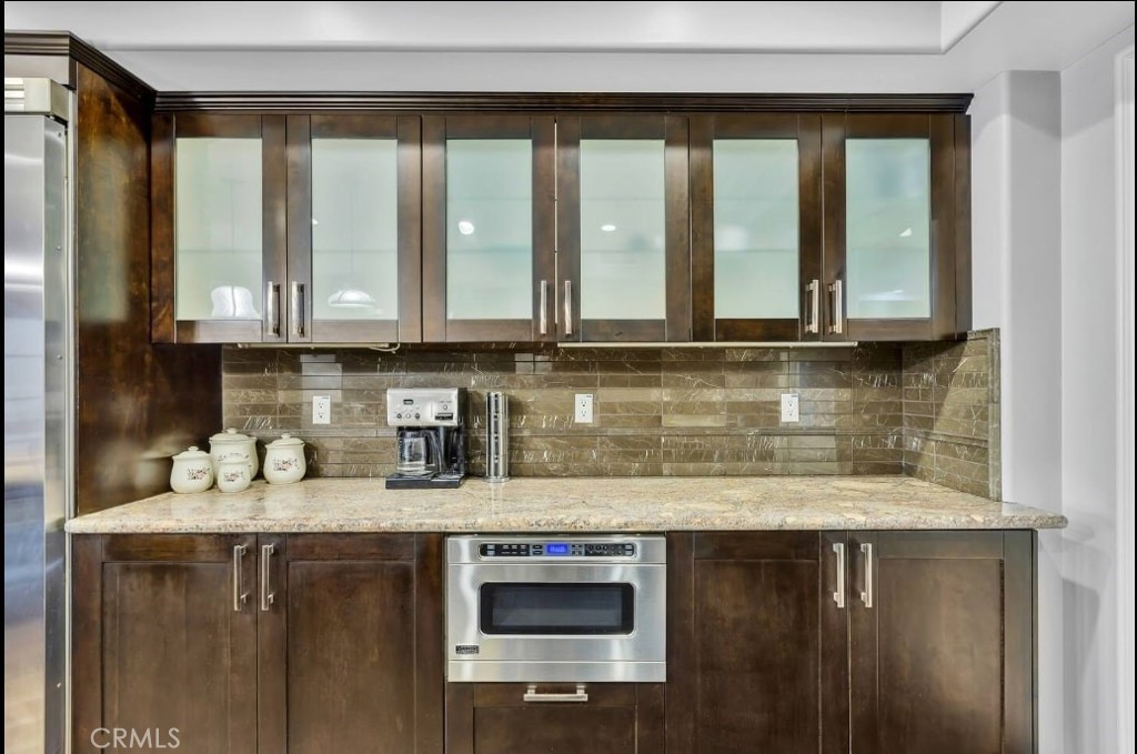 155 Cordova Street, Unit 203 Pasadena, CA 91105 - Photo 21 of 57 a kitchen with stainless steel appliances granite countertop a sink and cabinets with wooden floor