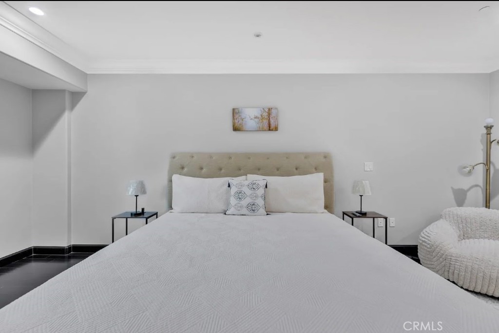 155 Cordova Street, Unit 203 Pasadena, CA 91105 - Photo 36 of 57 a bedroom with a bed and a night stand