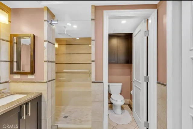 a bathroom with a granite countertop sink and a bathtub