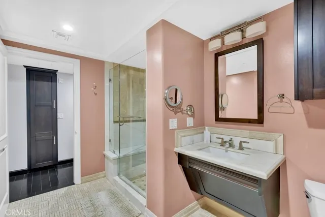 a bathroom with a granite countertop sink a mirror and a bathtub
