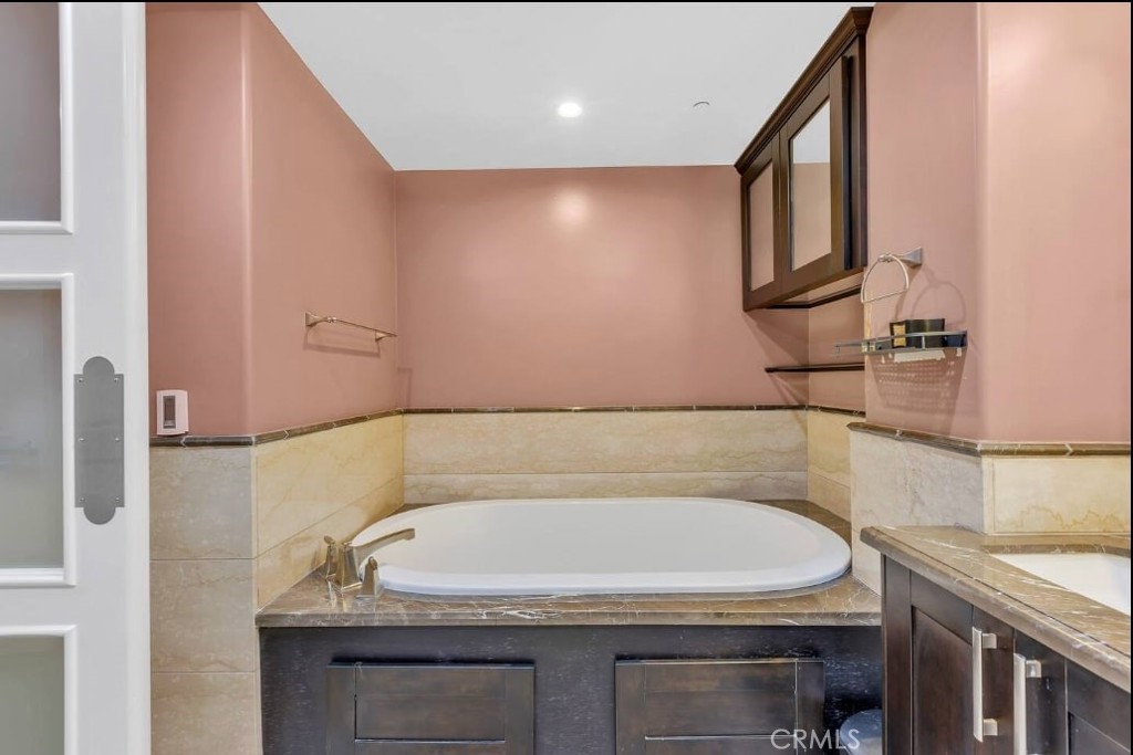 155 Cordova Street, Unit 203 Pasadena, CA 91105 - Photo 45 of 57 a bathroom with a granite countertop sink and a bathtub