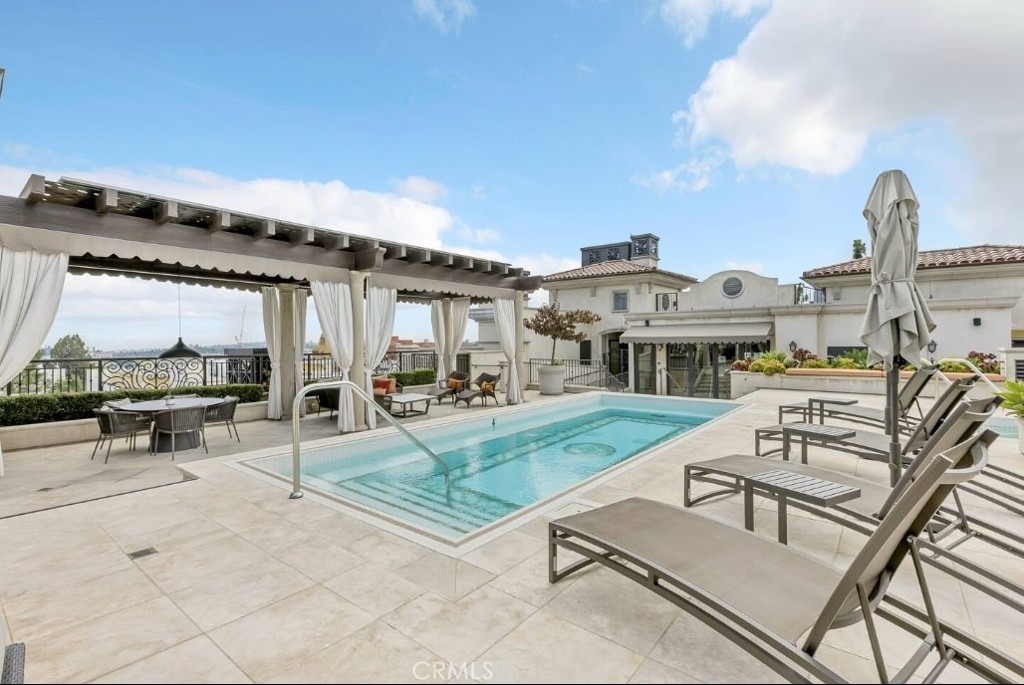 155 Cordova Street, Unit 203 Pasadena, CA 91105 - Photo 57 of 57 a view of a patio with couches table and chairs under an umbrella