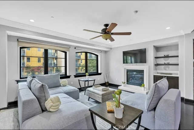 a living room with fireplace furniture and a large window